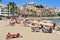 Sunbathers in Ses Figueretes Beach in Ibiza Town, Spain