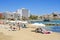 Sunbathers in Ses Figueretes Beach in Ibiza Town, Spain