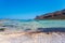 Sunbathing people on gritty beach of Balos lagoone on Crete. Greece.