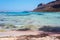 Sunbathing people on gritty beach of Balos lagoone on Crete. Greece.