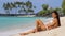 Sunbathing suntan bikini woman relaxing on beach vacation