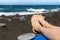 Sunbathing - woman feet on black sand beach