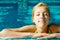 Sunbathing young girl at the swimming pool