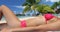 Sunbathing young woman on relaxing on beach in bikini on vacation beach travel