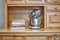 Sunbeam Mixmaster and cook books on shelf of a sideboard