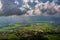 Sunbeam passing through the cloud over Chiangrai city with green grass field and mountain range. the areal shot has been taken thr