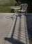 Sunbeam shine through the bridge and refect the white metal chair and the table with river view