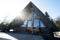 Sunbeam terrace of wooden triangle country tiny cabin house in mountains and two chairs