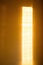 Sunbeam on yellow wall of house. Surface texture with sun glare.