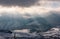 Sunbeams through clouds over the snowy mountains