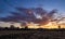 Sunbeams with red clouds and wheat field