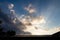 Sunbeams shine over rain clouds during sunrise in rural Illinois