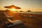 Sunbeds on empty sand beach by the sea at sunset, Montenegro, Ulcinj,.Long beach