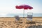 Sunbeds and parasol beach umbrella at the sunny beach in Italy