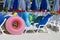 Sunbeds, parasols and rubber rings on the beach