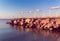 Sunbeds on the rocky pier by the sea