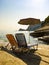 Sunbeds and umbrella on rocky beach in Corfu Island, Greece