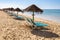 Sunbeds and umbrellas on Falesia Beach