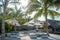 Sunbeds and umbrellas near beautiful beach at the tropical resort island