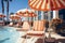 Sunbeds and umbrellas near swimming pool in luxury hotel resort