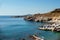 Sunbeds and umbrellas on rocky seashore