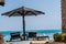 Sunbeds under parasol on the beach of the Red Sea