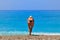 Sunburned young woman leaning at seashore