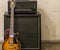 Sunburst electric guitar standing in front of a amplifier and sound effect box, professional music equipment