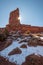 Sunburst peeks from behind a towering rock in Valley of the Gods in Utah