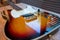 Sunburst vintage electric guitar gold hardware on wooden table in the room. business and music concept. Wallpaper or background