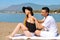 Suncare couple on a summer beach vacation have good skincare with high spf sunblock. Couple applying suncream. Handsome man