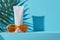 Suncream sun lotion packaging mockup tube on a bright sunny background with tropical palmtree leaf