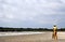 Sundarban National Park, Bangladesh: A park ranger with a gun standing on a beach on the Bay of Bengal