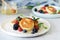 Sunday breakfast with cheesecake, honey, fresh berries and mint. Cottage cheese pancakes or curd fritters decorated honey