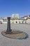 A sundial made of an old cast iron bollard for mooring ships, against the background of the Vladivostok railway station