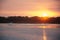 Sundown on the river. Yacht in rays of the setting sun