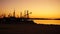 Sundown with shadows of Cranes and boats on the shore of Croatia