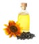 Sunflower, bottle of oil and seeds on white background