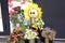 Sunflower doll next to other flowers