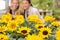Sunflower flowerbeds in focus two woman smiling