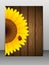 Sunflower and ladybird on wooden background.