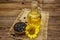 Sunflower oil in glass cruet with flower head and seeds in wooden bowl