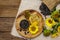 Sunflower oil in glass cruet with flower head and seeds in wooden bowl