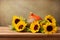 Sunflowers and pumpkin on wooden table