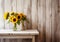 Sunflowers in a vase on a wooden background, a radiant composition with text space