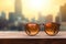 A sunglass on wooden board on blur beach with bokeh background