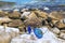 Sunglasses blue aviator on the beach rocks