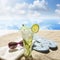 Sunglasses drink in sand on beach