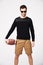 Sunglasses, fashion and man in studio with football for confident, pride and stylish clothing. Fitness, sport and