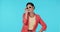 Sunglasses, fashion and a model woman winking in studio on a blue background for trendy style. Portrait, shades and